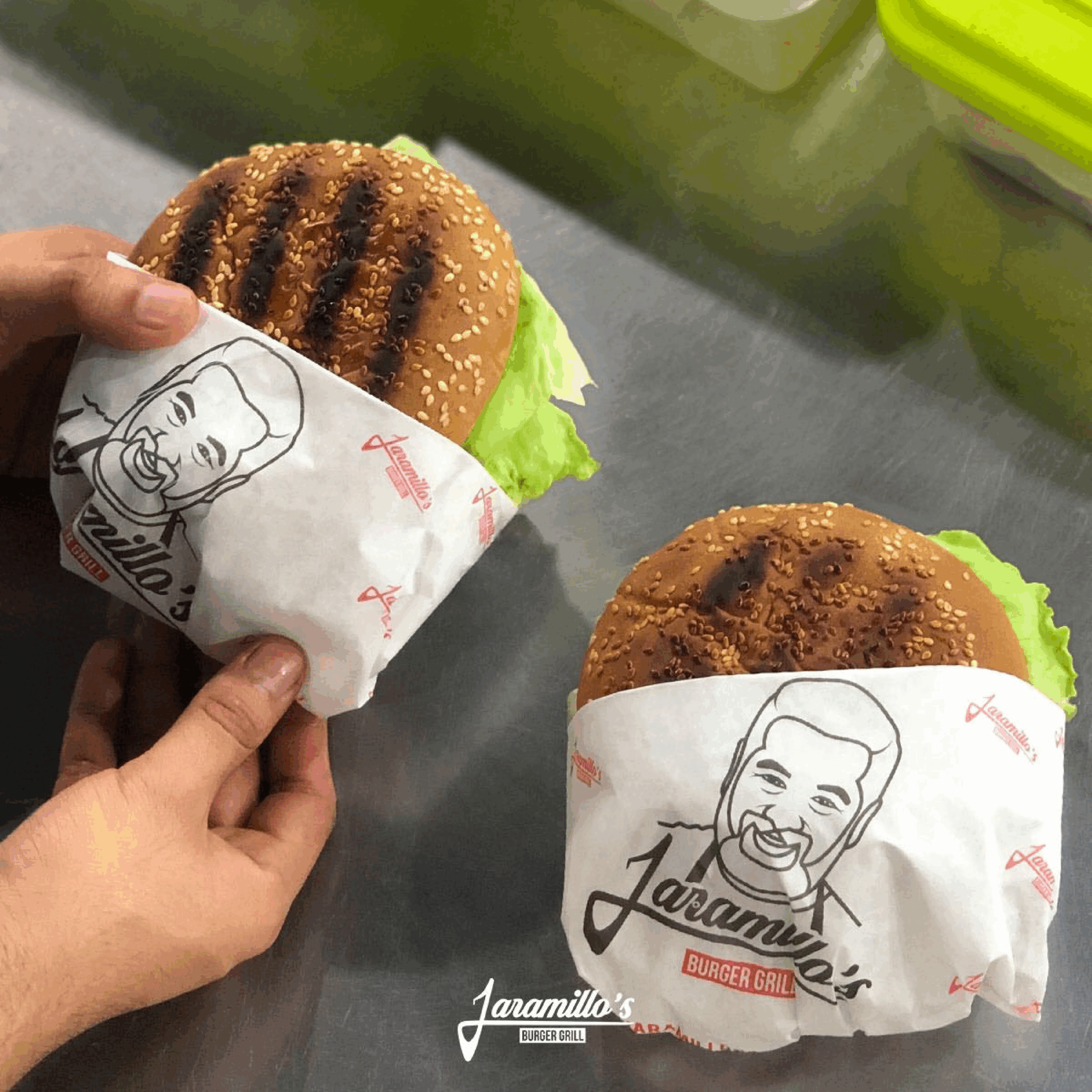 Hamburguesas al carbón envueltas con logo Jaramillo’s Burger Grill en Monterrey